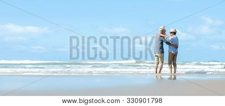 Asian Lifestyle Senior Couple Dancing On The Beach Happy And Relax Time.  Tourism Elderly Family Tra