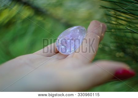 Female Hand With Transparent Amethyst Quartz Yoni Egg For Vumfit, Imbuilding Or Meditation. Shining 
