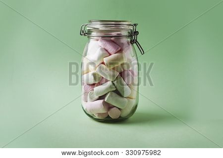 Jar With Marshmallows In Pastel Color On Lightgreen Background