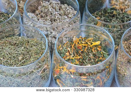 Set Of Various Herbs. Herbal Teas In Jars On A Wooden Table.