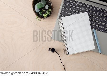 Podcast Recording, Education Concept. Laptop, Notepad, Microphone On A Wooden Table With Copy Space.