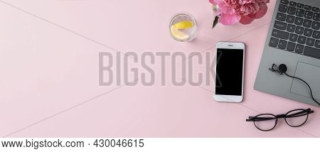 Concept For Business, Online Education, Freelancing. Laptop, Phone, Microphone, Glasses On A Pink Ba