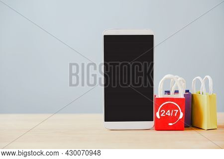 White Mobile Phone With Clipping Path On Touchscreen And Shopping Bag With 24 Hours 7day Service Ico