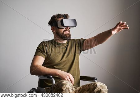 Disabled Ex-serviceman In A Wheelchair Using A Vr Headset