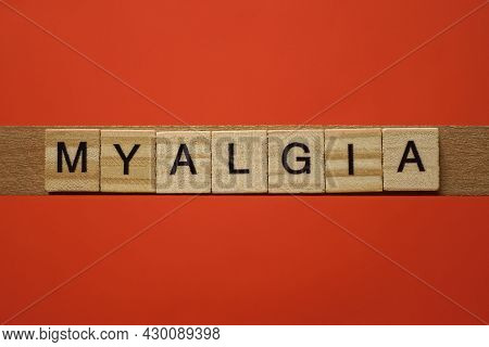 Text The Word Myalgia From Gray Wooden Small Letters With Black Font On An Red Table