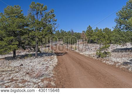 Red Dirt Road In A Volcanic Landscape In El Malpais National Monument In New Mexico