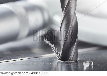 Metal Drill Bit Make Holes In Steel Billet On Industrial Drilling Machine. Metal Work Industry. Mult