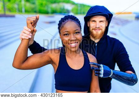 Smiling Young Mixed Race Couple In Sportswear Warming Up Outdoors Sity Background Early Morning