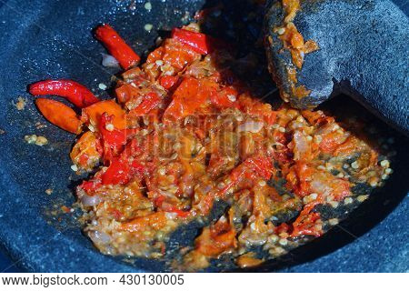 Red Chili Sauce On A Stone Mortar And Pestle