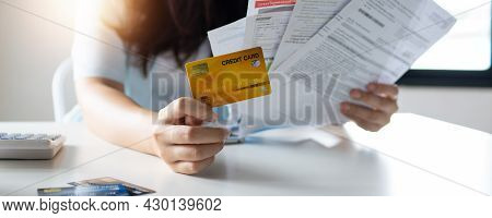 Hand Of Woman Holding Credit Card And Accrued Bill, Debt And Bankrupt Concept