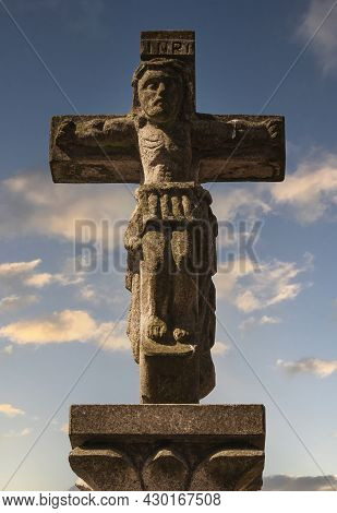 Romanesque Symbol Of The Cross On The Camino De Santiago With Sunset Sky In The Background. Composte