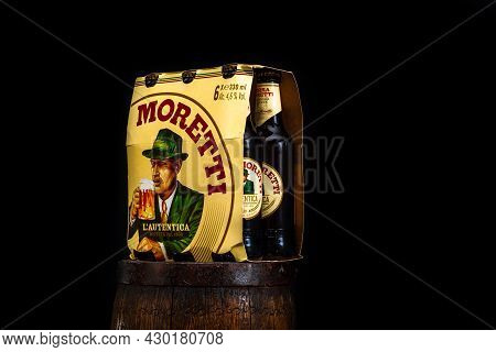 6 Pack Of Birra Moretti Beer On Wooden Barrel With Dark Background. Illustrative Editorial Photo Buc