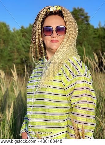 Pretty Woman With Curly Hair Stands On The Sand Dune And Looks At The Sunset Over The Baltic Sea In 