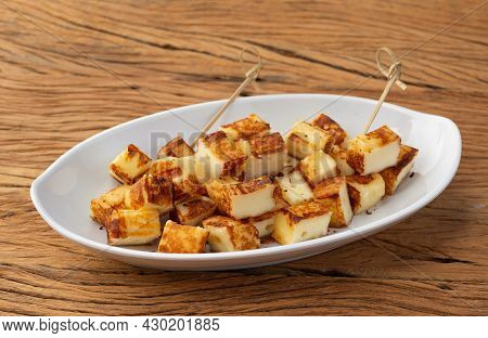 Grilled Rennet Or Coalho Cheese On A White Plate With Pepper.