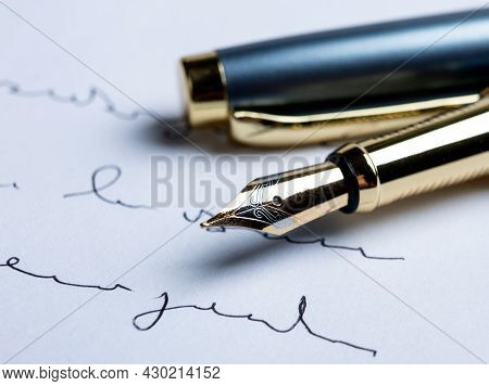Fountain Pen On Paper With Ink Text On The Paper Closeup