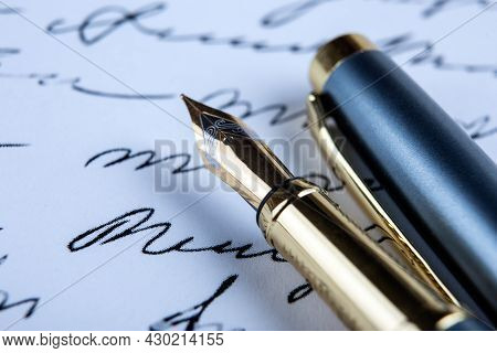Fountain Pen On Paper With Ink Text On The Paper Closeup