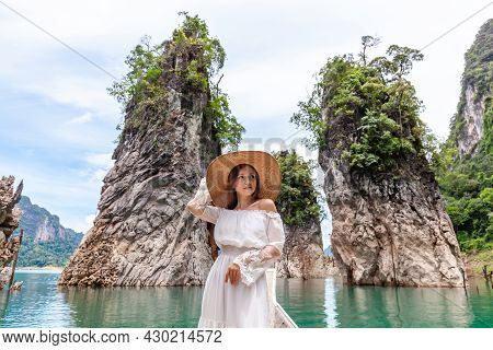 Happy Young Female Tourist In Dress And Hat At Longtail Boat Near Famous Three Rocks With Limestone 