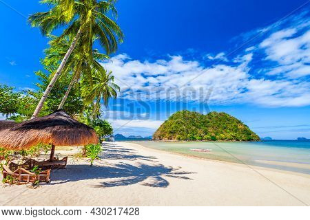 Beach With White Sand, Coconut Palms And Turquoise Water In El Nido Province, Palawan Island In Phil