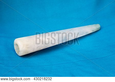 Clay Chillum For Marijuana Smoking On A Blue Fabric Background