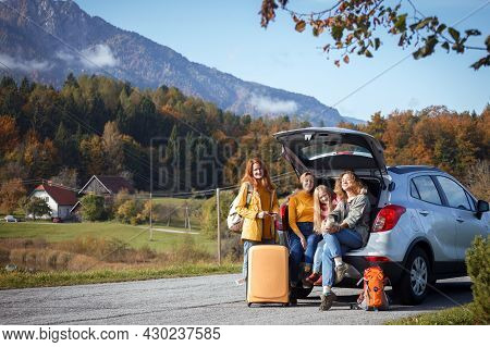 Big Family Trip - Happy Girls Travel By Car. Mamma With Daughters Sitting In The Boot