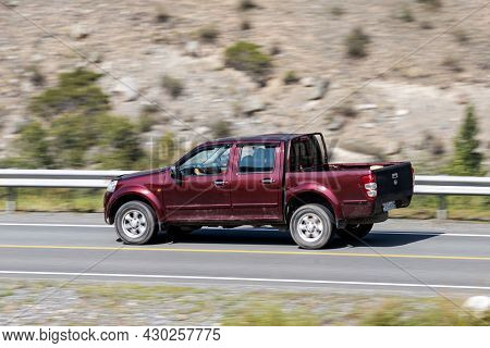 Novosibirsk, Russia - August 08, 2021:   
Red Toyota Hilux Pickup  Driving Fast On Freeway In Highla