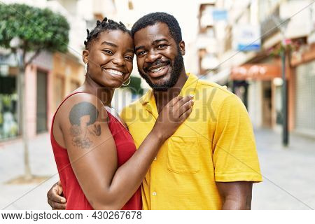 Young afircan american couple smiling happy and hugging at the city.