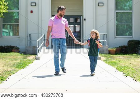 School Boy Going To School With Father. Parent Taking Child To School. Pupil Of Primary School Go St