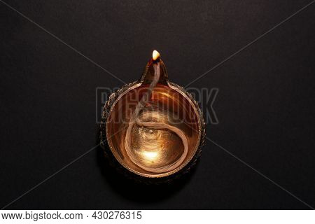 Lit Diya On Dark Background, Top View. Diwali Lamp