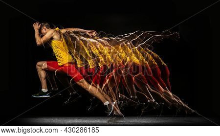 Portrait Of Young Man, Professional Male Athlete, Runner In Motion And Action Isolated On Dark Backg