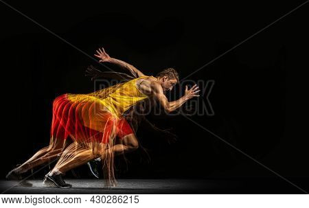 Portrait Of Young Man, Professional Male Athlete, Runner In Motion And Action Isolated On Dark Backg