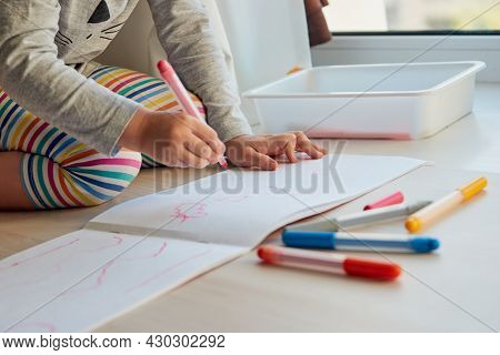 3 Years Girl Draws A Picture. Child At Home, Kindergarden And Preschool Closed During Covid-19