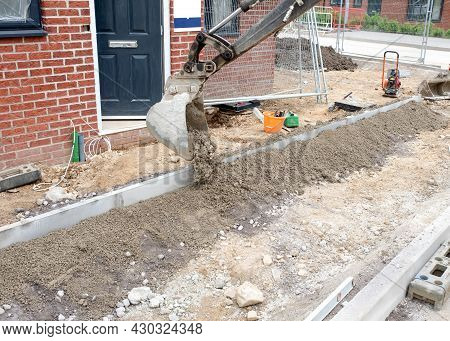 Installation Of Edging Kerb During Footpath Construction In Front Of New Build House On New Housing 