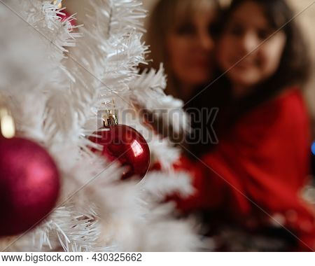 Aughter And Mother In Christmas Sweaters Near Christmas Tree At Home
