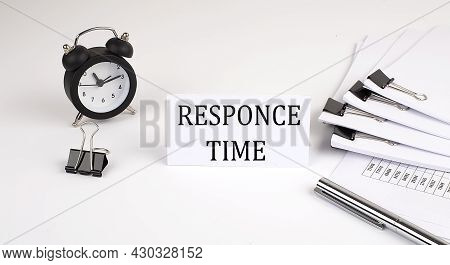 Card With Text Responce Time On A White Background, Near Office Supplies And Alarm Clock. Business