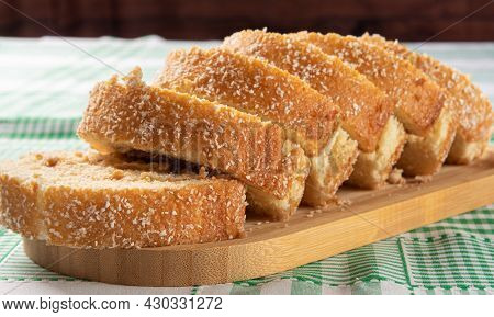 Rocambole, Sliced ​​rocambole Stuffed With Dulce De Leche On A Wooden Tray On A Table With Checkered