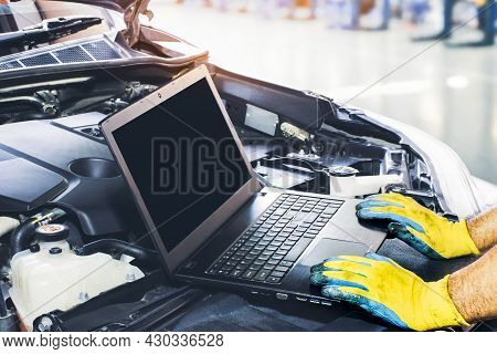 Technician Tuning Engine Car With The Computer Laptop In Repair Garage,blank Display