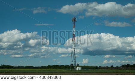 G5 Cell Phone Tower Base Station Against Blue Sky With Clouds. Waves Might Increase The Risk Of Heal
