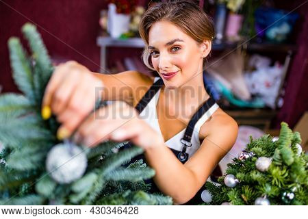 Small Business Owner Arranging Little Decorative Tree Indoor Studio
