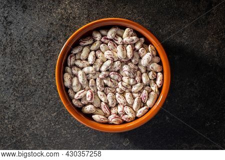 Cranberry beans. Borlotti beans in bowl. Top view.