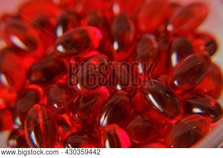 Krill Oil Capsules Background.omega Fatty Acids. Natural Supplements And Vitamins.red Capsules With 