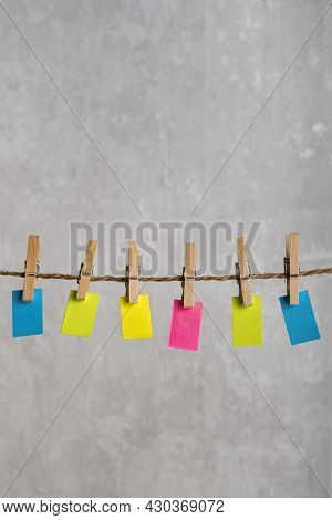 Bright Small Notes Hang With Clothespins On Rope. Copy Space. Place For Your Text. Vertial Frame