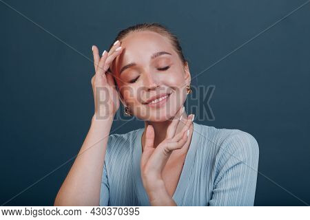Millenial Young European Woman Blonde Hair Portrait Doing Face Yoga Self Facebuilding Massage For Fa