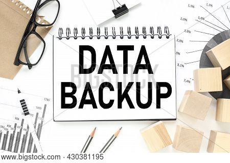 Data Backup. On A White Table On The Background Of Financial Charts