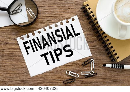 Finansial Tips. Text On Wood Table, On White Paper