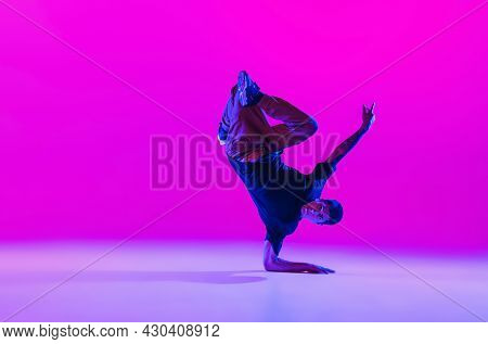One Dancing Man, Break Dancer In Action, Motion In Modern Clothes Isolated Over Bright Magenta Backg