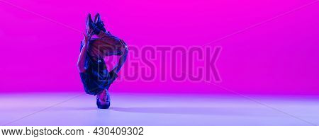 Portrait Of Young Man, Break-dance Dancer Dancing Solo In Modern Clothes Isolated Over Bright Magent