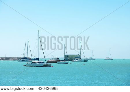 Turquoise water of the Atlantic Ocean and yachts in the foreground. Summer vacation concept background