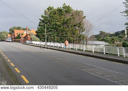 Wellington New Zealand - July 30 2021; One Person Wearing High Vis Jacket Walking Up Bolton Street I