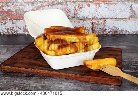 Chips And Gravy Meal In A Take Away Box With Lid