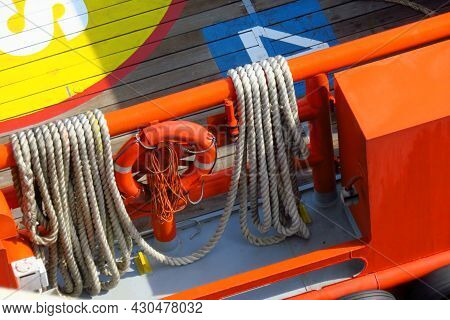 Life Buoy And Big Rope Hanging On The Handrail Of Supply Boat For Support Oil And Gas Industry.